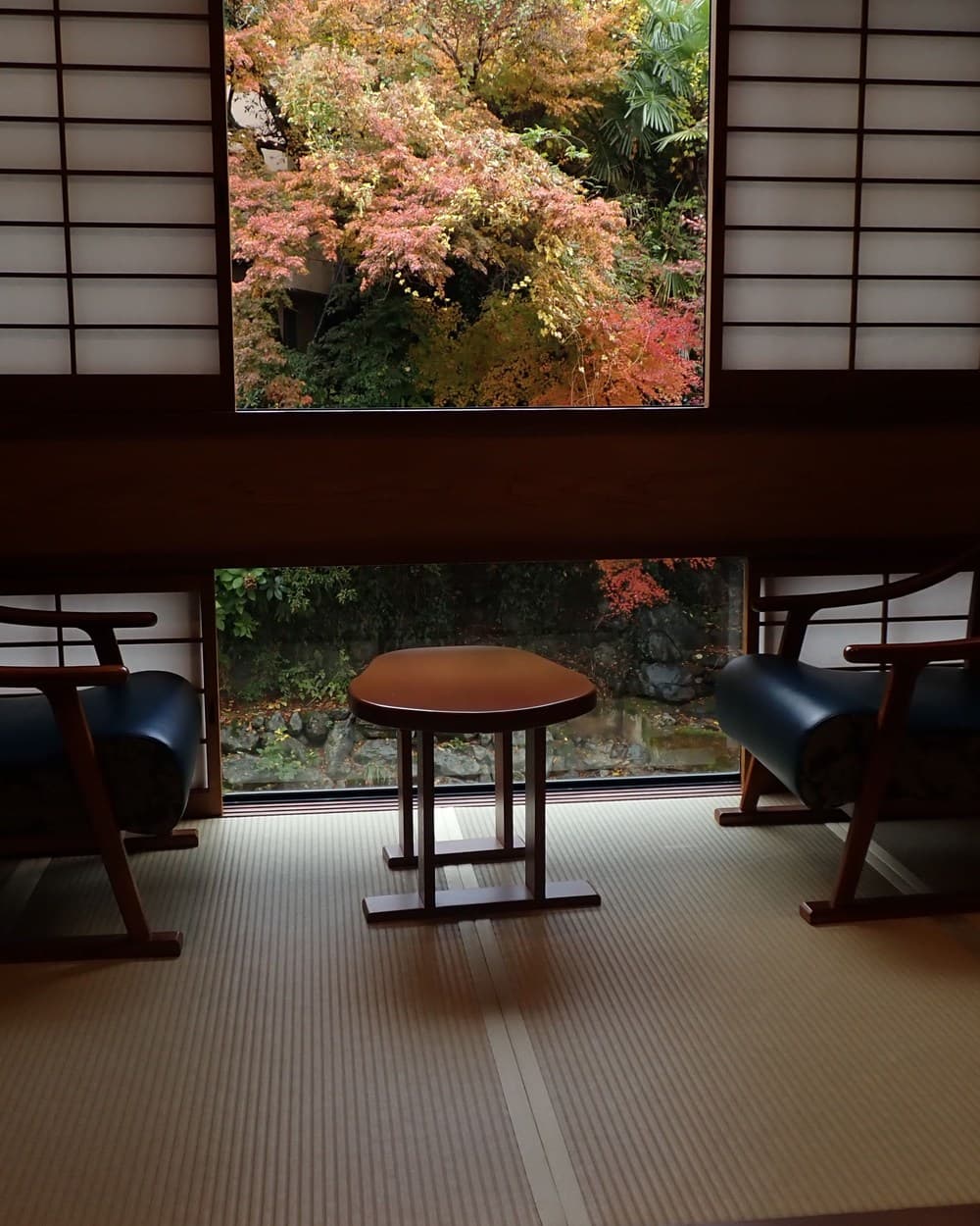 A tatami room in a Japanese ryokan overlooking an autumn garden
